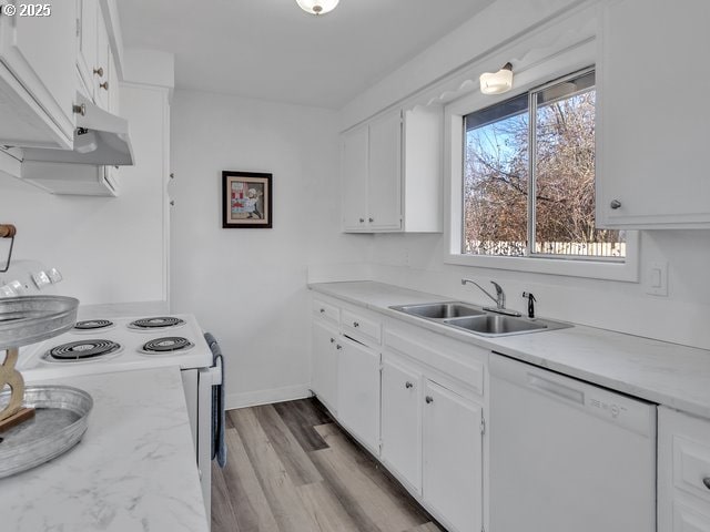 kitchen with white cabinetry, sink, white appliances, and light hardwood / wood-style flooring