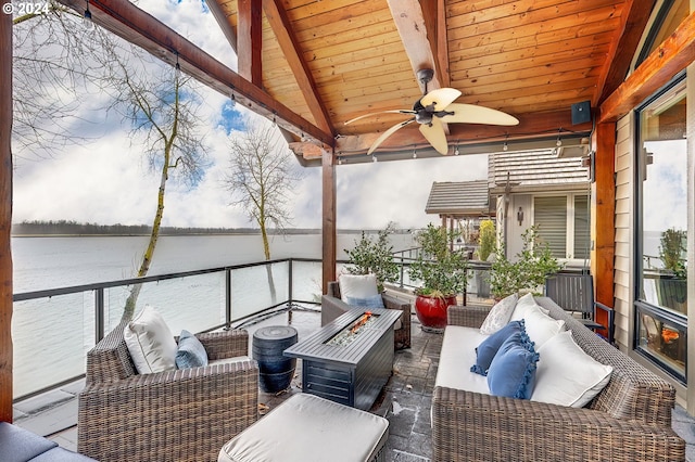 exterior space with ceiling fan, vaulted ceiling with beams, wood ceiling, and a water view