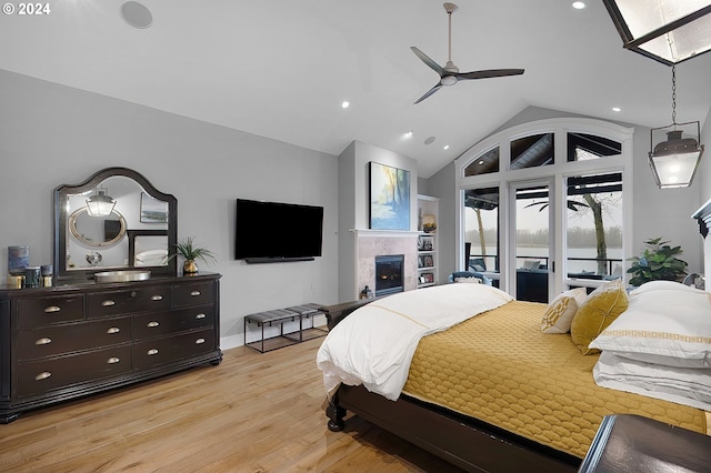 bedroom featuring light wood-type flooring, vaulted ceiling, ceiling fan, and access to exterior