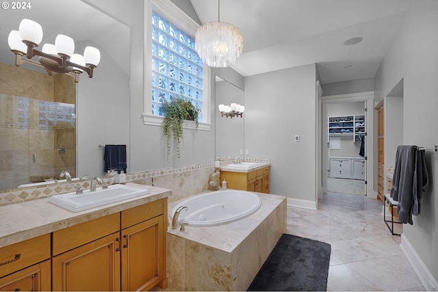 bathroom with tile patterned flooring, vanity, separate shower and tub, and a chandelier