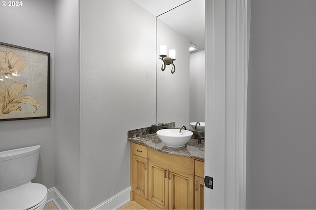 bathroom featuring vanity and toilet