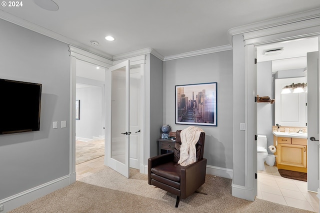 sitting room with light colored carpet, sink, and crown molding