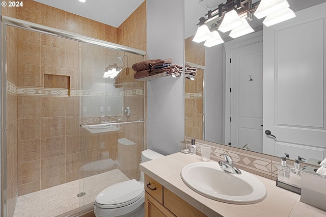 bathroom with a shower with door, toilet, and vanity