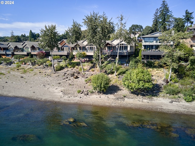 back of house with a water view