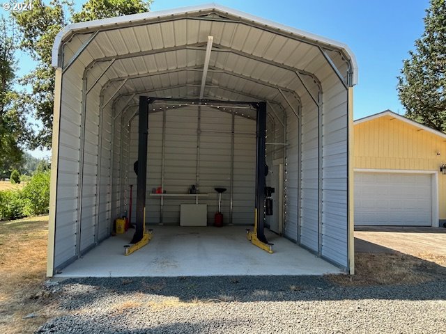 exterior space with a carport and a garage