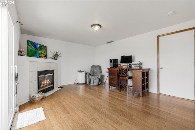 office area featuring hardwood / wood-style flooring and a fireplace