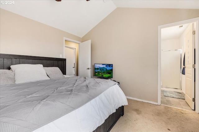 bedroom featuring ceiling fan, ensuite bathroom, light carpet, and lofted ceiling