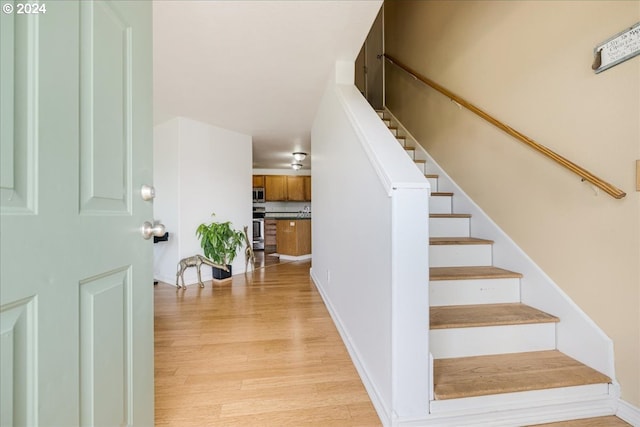 stairs with hardwood / wood-style floors