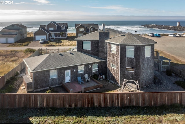 rear view of house with a beach view and a water view