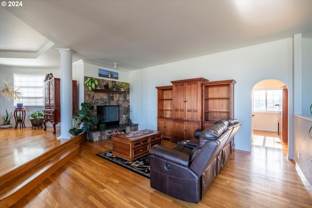 living room with light wood-type flooring and a fireplace