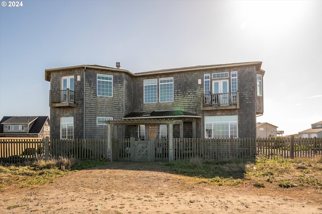 back of property featuring a balcony