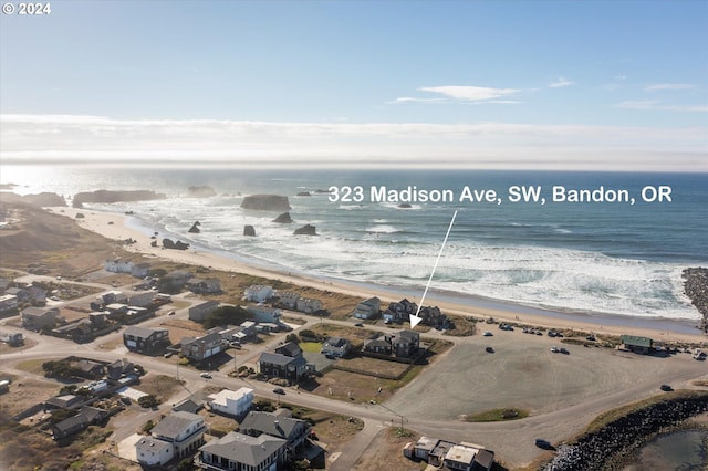 bird's eye view featuring a view of the beach and a water view