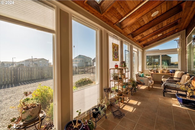 sunroom with lofted ceiling, wooden ceiling, and a wealth of natural light