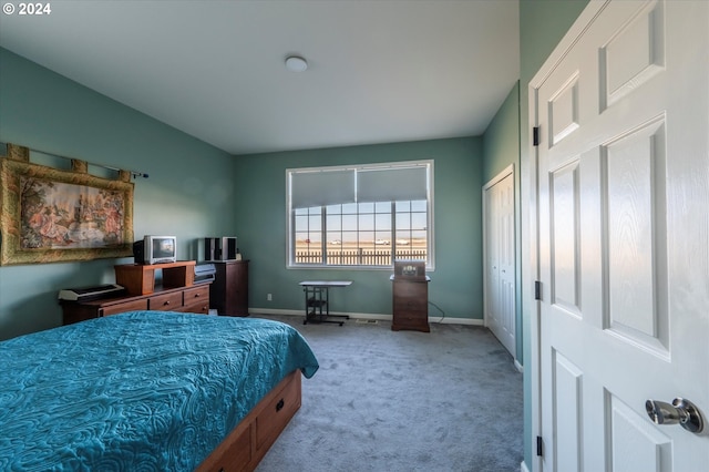 carpeted bedroom featuring baseboards