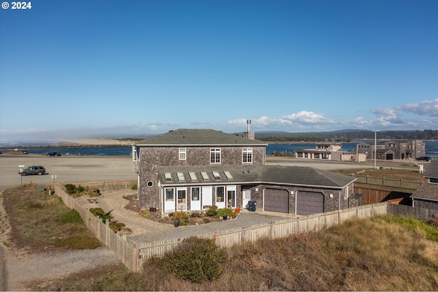 view of front of house with driveway, fence private yard, and an attached garage
