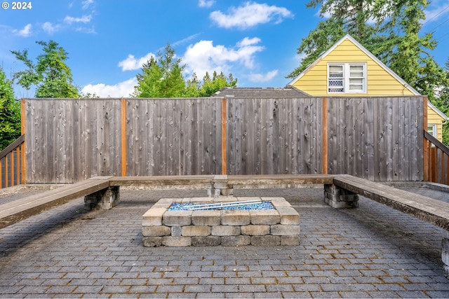 view of patio with a fire pit