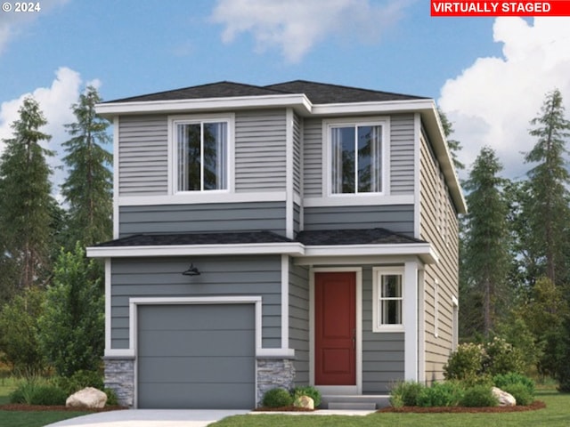 view of front of property featuring a garage and a front lawn