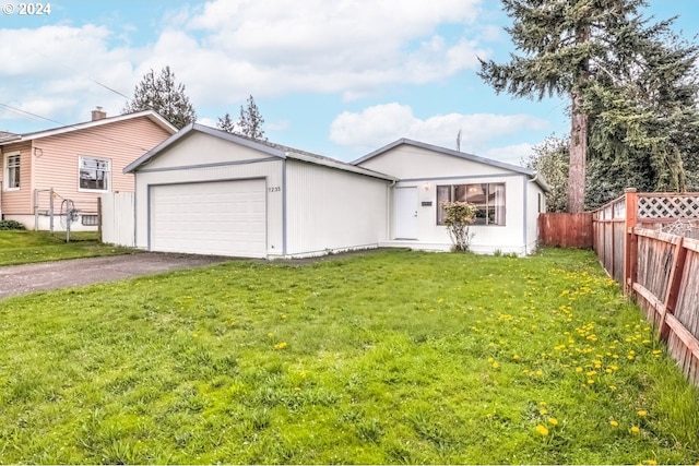 view of front facade featuring a front yard and a garage