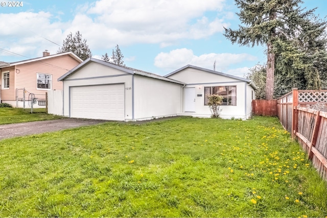 view of front of property featuring a front lawn and a garage