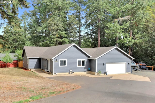 ranch-style house with a garage and a front lawn