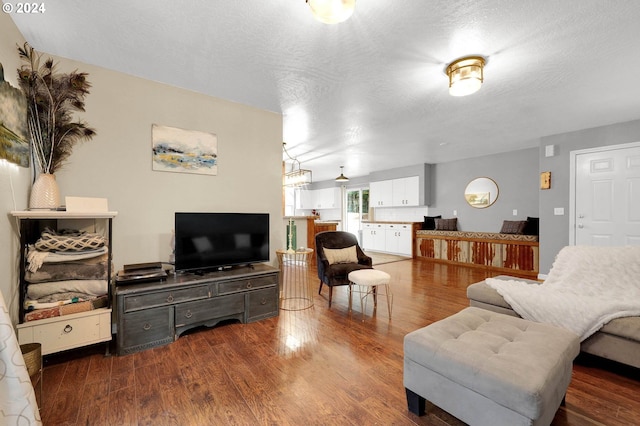 living room with dark hardwood / wood-style floors and a textured ceiling