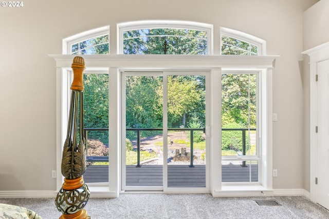 entryway with carpet and lofted ceiling