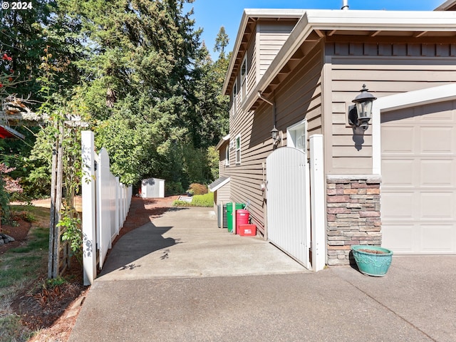 view of property exterior with a storage shed