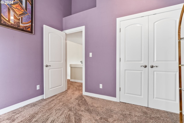 unfurnished bedroom with carpet flooring and a closet