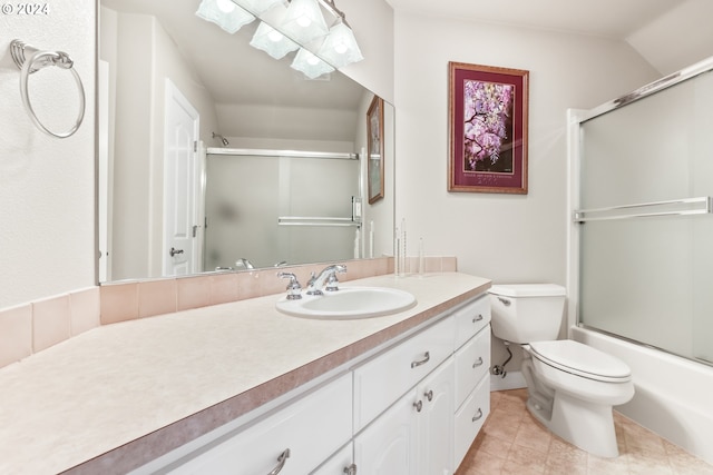 full bathroom featuring combined bath / shower with glass door, tile patterned floors, vanity, toilet, and lofted ceiling