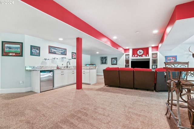 carpeted living room featuring built in shelves and indoor wet bar