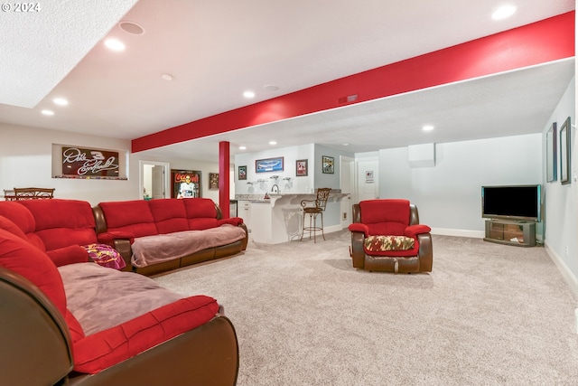 carpeted living room featuring bar area