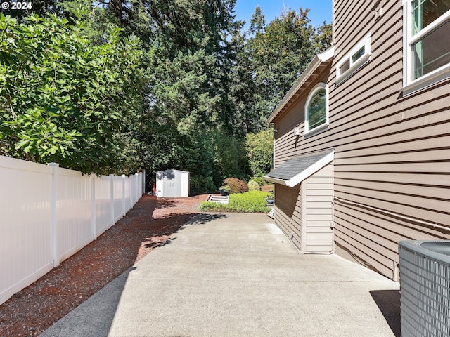 view of patio featuring a shed and central AC unit