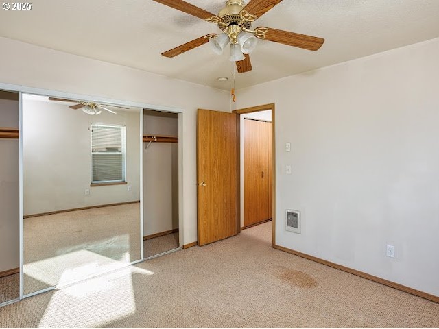 unfurnished bedroom featuring ceiling fan and light colored carpet