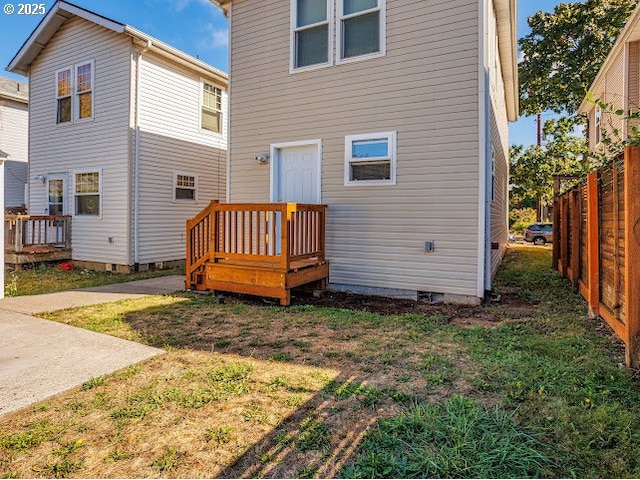 rear view of house featuring a yard