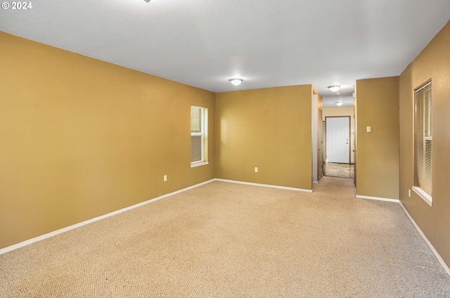 spare room with light colored carpet