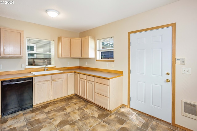 kitchen featuring sink, light brown cabinets, and black dishwasher