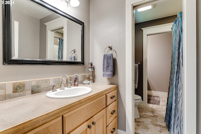 full bath featuring vanity and toilet