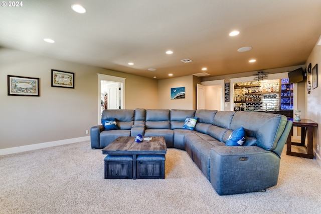 carpeted living room with baseboards, visible vents, and recessed lighting