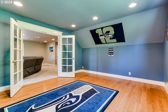 interior space featuring french doors, recessed lighting, lofted ceiling, wood finished floors, and baseboards