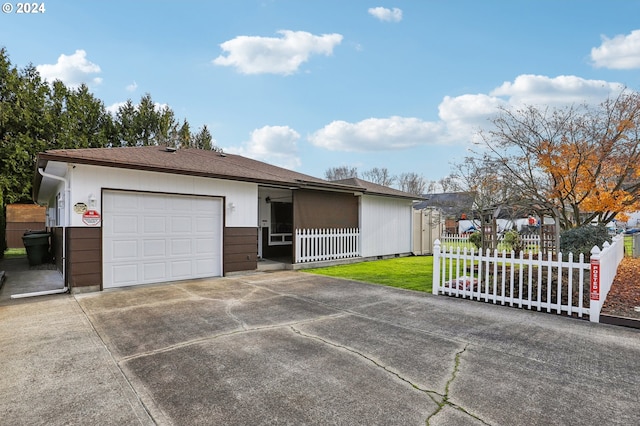 single story home with a garage and a front yard