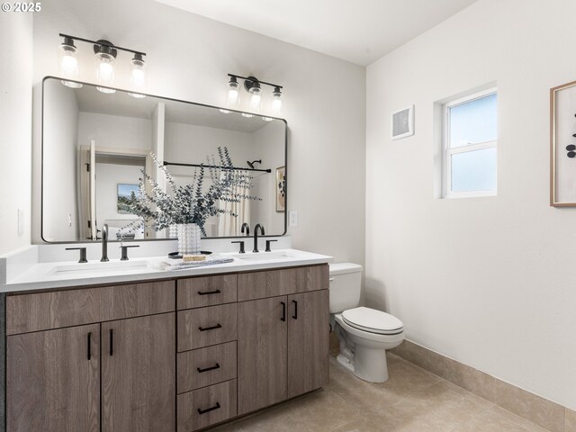 full bathroom featuring double vanity, toilet, visible vents, and a sink