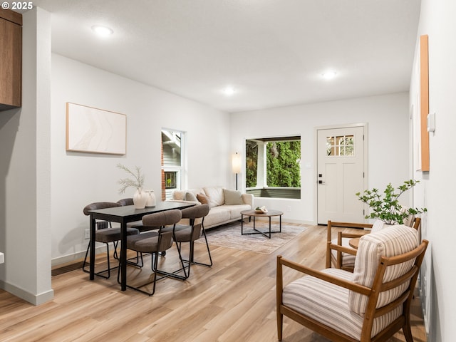 dining space with light wood finished floors, recessed lighting, and baseboards