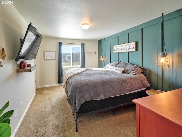 carpeted bedroom featuring a textured ceiling