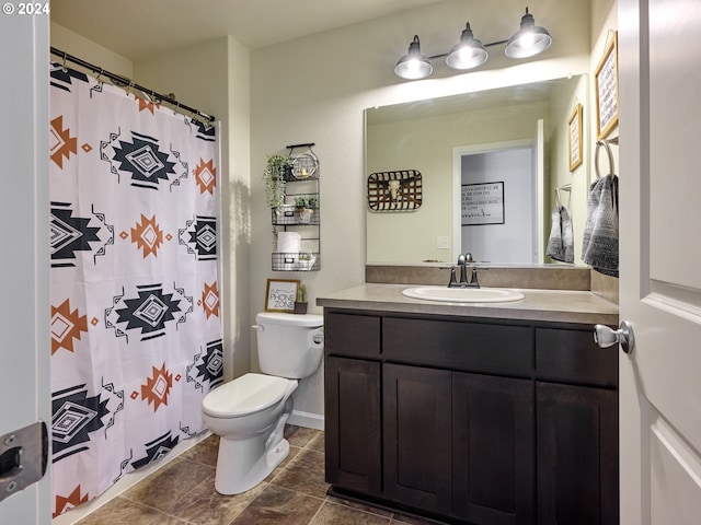 bathroom with toilet and vanity