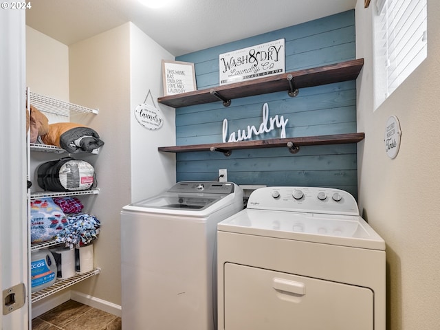 clothes washing area with separate washer and dryer and a textured ceiling