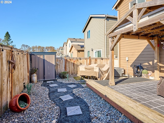 view of yard featuring cooling unit and a patio