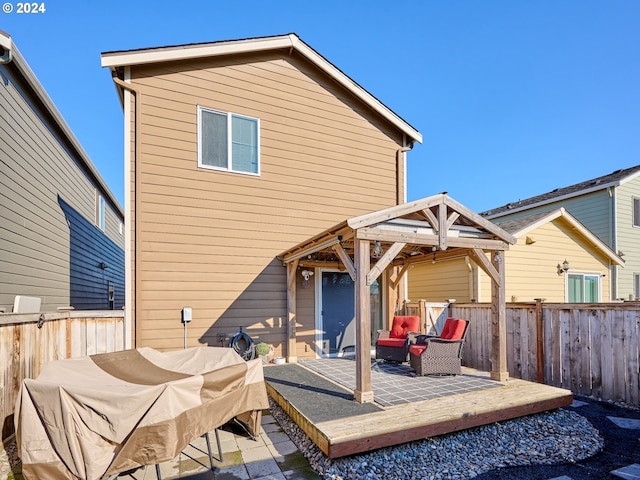 rear view of house featuring a wooden deck