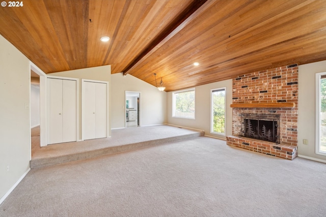 unfurnished living room featuring a fireplace, wood ceiling, light colored carpet, and vaulted ceiling with beams