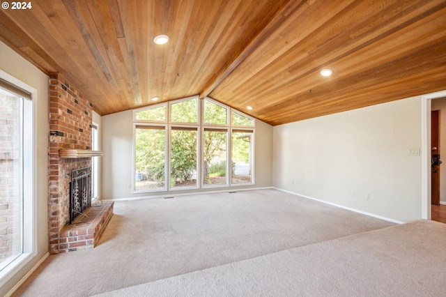 unfurnished living room featuring plenty of natural light, a brick fireplace, and lofted ceiling with beams