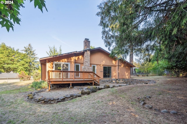 back of property with a wooden deck